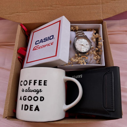 عرض علوي كامل للصندوق الفاخح البني المفتوح يظهر محفظة Zara جلدية، ساعة Casio فاخرة، عطر Sean معطر، كوب قهوة، وردة حمراء في صندوق براق، صور خاصة، شريط أحمر ساتان، وزهور جافة معطرة.