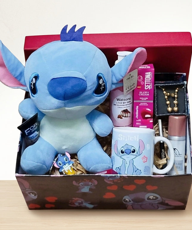بوكس ستيتش عشق الزرقاء - دمية Stitch بعينيها الكبيرة الحمراء مع كوب قهوة Stitch بتصميم جميل، قلادة Stitch ذهبية فاخرة، مجوهرات صغيرة أنيقة، خلفية متدرجة من الأرجواني إلى الأزرق جميلة جداً - تصوير احترافي - هدية حب فاخرة من كنوز مصر

